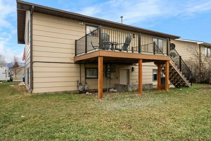 Entire duplex: Backyard lawn and rear deck of the duplex