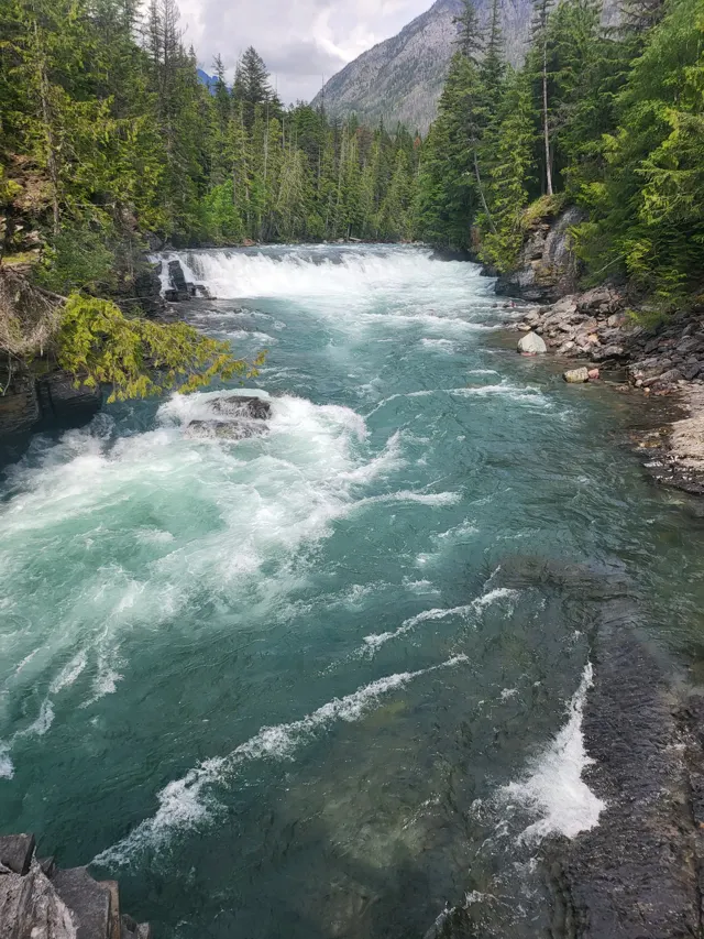 Turquoise river rushing through a rocky gorge in Glacier