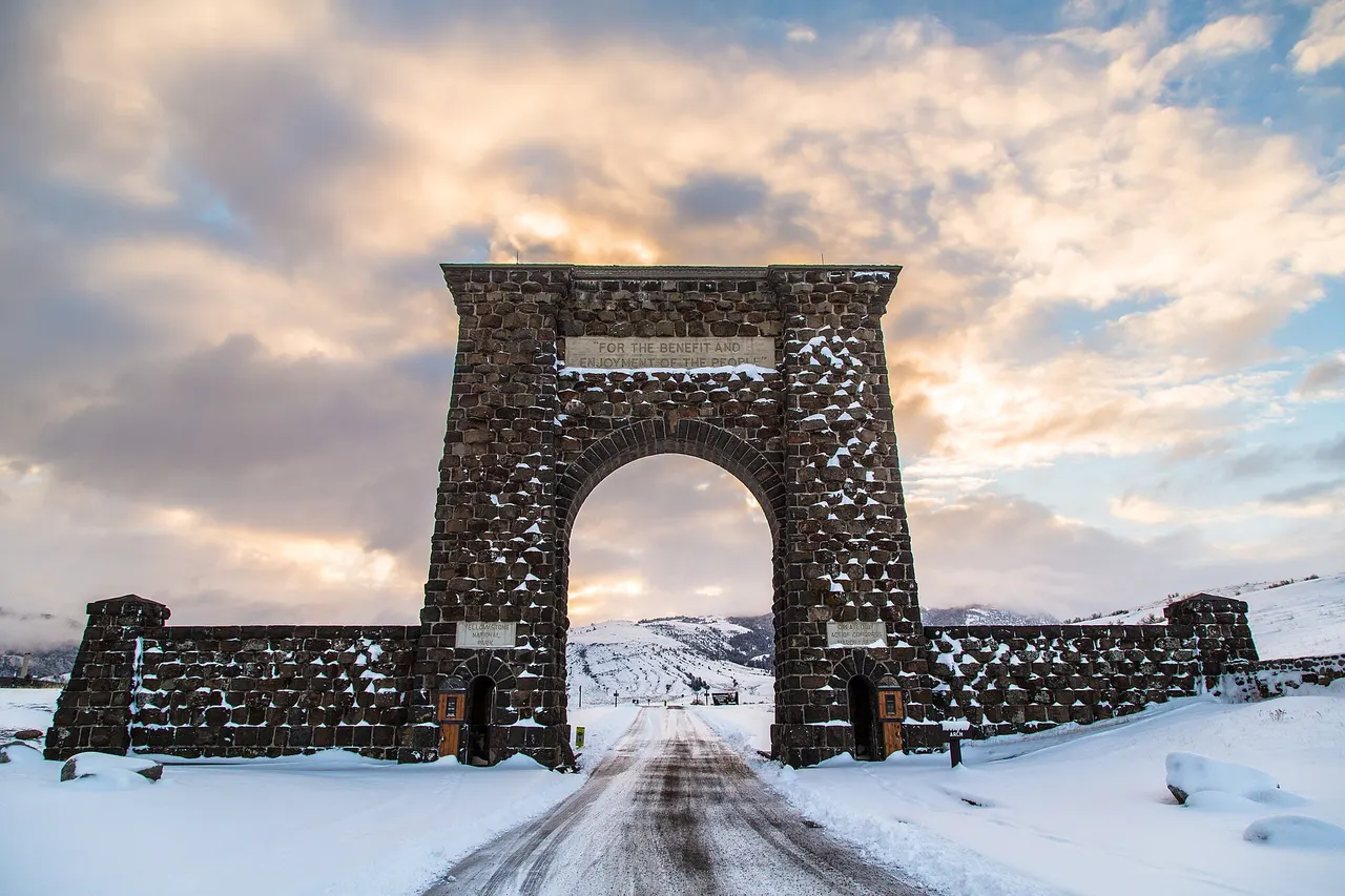 The Roosevelt Arch at Yellowstone’s North Entrance in Gardiner, Montana, at sunrise in winter