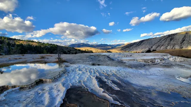 White travertine terraces with mountains behind in Yellowstone